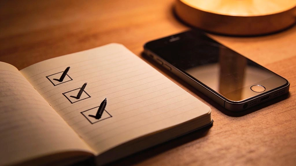 verification steps: handwritten checklist with 3 checkboxes and a pen, no readable text